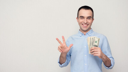 Concept of microloans. Person with the cash dollars showing number three with fingers, white background, copy space, 16:9