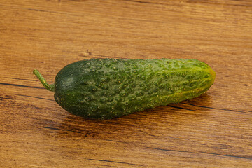 Green ripe fresh cucumber over background