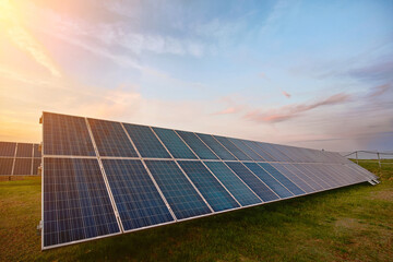 Solar power station, solar panel on sunset background. Photovoltaic technology, solar cells on evening sky background. Alternative electricity source, ecological renewable energy sources