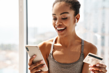 Sports african woman using mobile phone