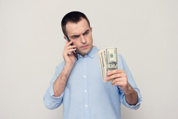 Man with american dollars on the phone, white background, copy space