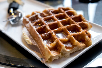 Delicious Belgian waffles with caramel and chocolate topping in the confectionary of Ljubljana, Slovenia