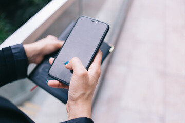 Unrecognizable woman messaging on smartphone