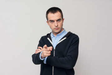 Portrait of a serious man pointing finger at you camera gesture, white background