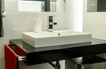 Modern bathroom with sink and soap/disinfection fluid (mock-up). Cleaning hands in washbasin.