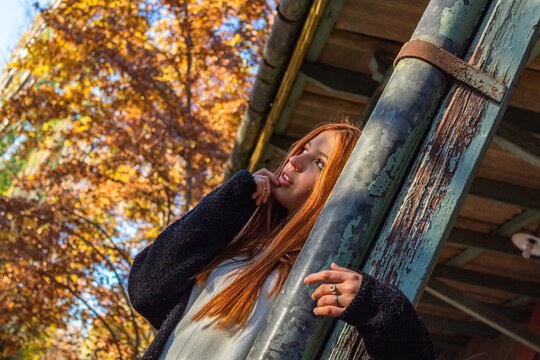 Beautiful redhead girl posing in the train stop.
