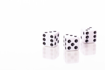 three white dice black pips showing three reflected in glass table surface isolated on white background copy space