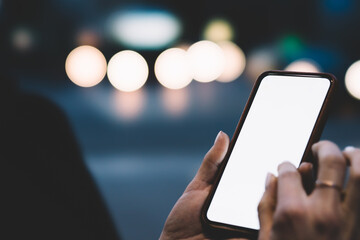 Crop person using smartphone on street