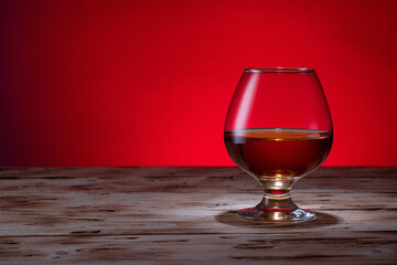 A glass of alcohol. Brandy on a beautiful table. Cognac on the background.