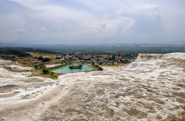 Fototapeta na wymiar Pamukkale, Turkey - may 2018: Tourists on Pamukkale Travertine pools and terraces. Pamukkale is famous UNESCO world heritage site in Turkey