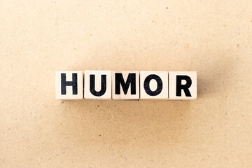 Letter block in word humor on wood background