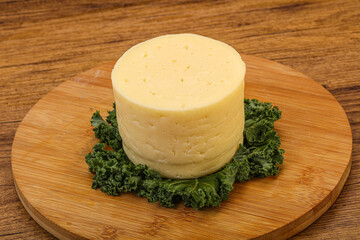 Yellow round dairy soft cheese