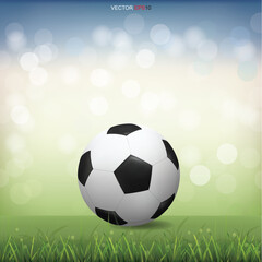 Obraz premium Soccer football ball on green grass field with light blurred bokeh background. Vector.