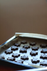 Making star shaped gingerbread cookies at home. Selective focus.