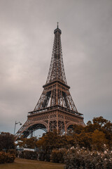 Eiffel tower on a cloudy autumn day. fall colors