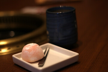 Close up of a delicious mochi ice-cream on a small plate, soft focus, Japanese dessert