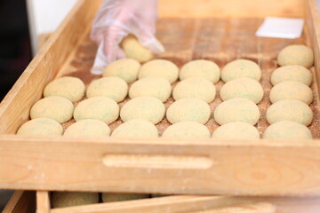 Close up of rows of green tea mochi (rice dumpling) with red bean fillings, Japanese food, soft focus