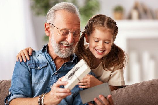 Grandfather And Granddaughter Opening Present