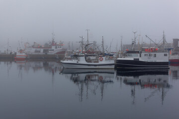 Fog in port of the polar town Vardo of the coast of the Barents sea, Varanger national scenic route in Finnmark, Norway