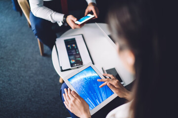 Unrecognizable woman using tablet in office