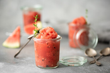 watermelon smoothie with basil and thyme in glass jars