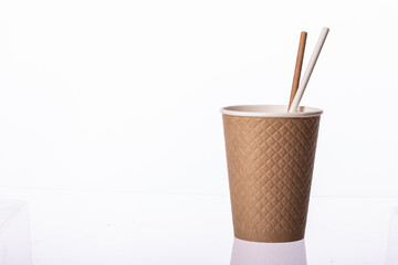 Disposable brown paper cup waffle texture with straws isolated on white background. Coffee to go, takeaway hot drinks, cafe, coffee shop, eco-friendly tableware concept, mockup template. Copy space