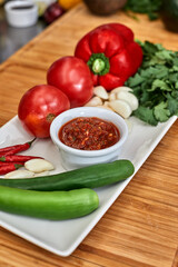 Many different spices, vegetables and ingredients, and fresh herbs for making homemade sauce