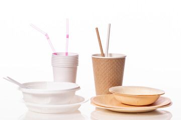 Plastic vs natural materials isolated on white background. Craft paper eco-friendly tableware against plastic dinnerware. Harmful pollution, environmental protection, recycling, ecology, concept