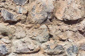 Old background. Grunge dirty old brick stone wall exterior. Ancient temple architecture.