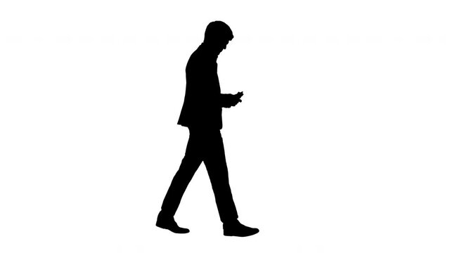 Silhouette Satisfied businessman counting money and tucking it inside his jacket while walking.