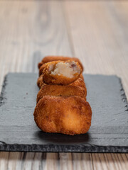 Fried Spanish ham Croquettes over a wooden background