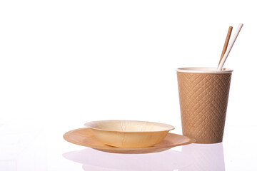 Set of biodegradable disposable tableware on white background. environmentally friendly modern ecological biomaterials, plastic replacement concept.