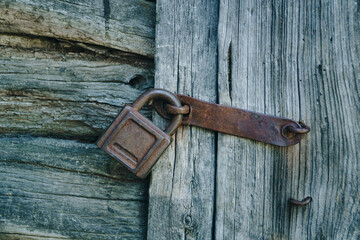 Old rusty lock on an old wooden door