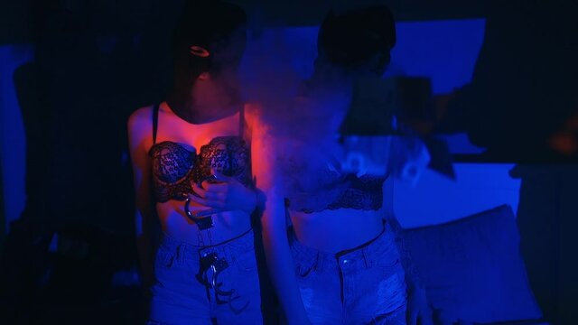 Girls in black masks of robbers with handcuffs in sexy underwear are allowed to steam out of the vape on the bed. Erotic role-playing lesbian games