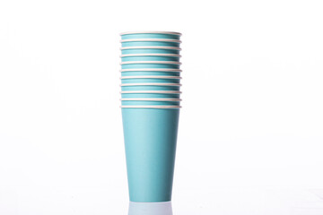 blue stacked disposable biodegradable paper takeaway cups isolated on white background. Plastic pollution reduction concept. Zero waste concept.