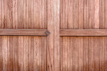 Textured natural brown wooden gate.