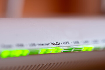 Blinking green led lights on home wifi modem close up macro shot , space for text.