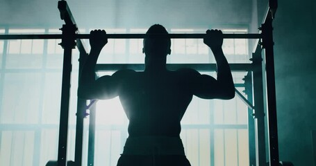Cinematic slow motion shot of a professional young muscular shirtless african man is practicing shadow boxing work out in a gym with ring.  - Powered by Adobe