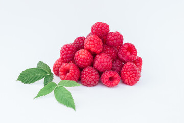 
a bunch of raspberries with a green petal on a white background