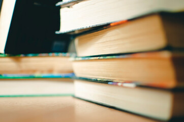 Lots of books in a bookstore or library. Selective focus, close-up.