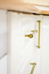white kitchen cabinets close-up.white kitchen drawers in classic style with handles.