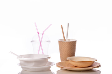 Contrast plastic and biodegradable disposable tableware isolated on white. pollution reduction concept. eco friendly modern ecological biomaterials. Zero waste concept. plastic replacement concept