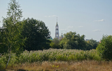 View from the bank of the Tsna river to the bell tower of the Kazan monastery in the city of Tambov, Russia.
