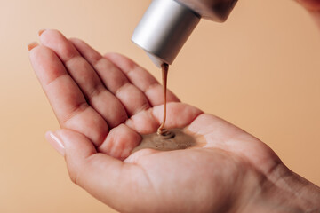 Girl pours chocolate shampoo into her hand