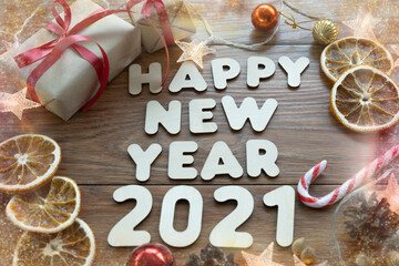 Happy new year 2021. Christmas composition. New year's layout on a dark wooden background. Cones, toys, gift, garland