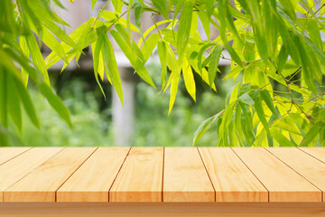 Wood floor with blurred trees of nature park background and summer season, product display montage