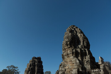 The Bayon is a richly decorated Khmer temple with the multitude of serene and smiling stone face stands at the center of Angkor Thom, Siem Reap, Cambodia.