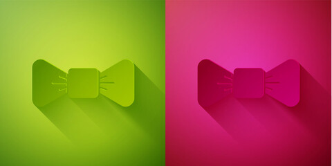 Paper cut Bow tie icon isolated on green and pink background. Paper art style. Vector.