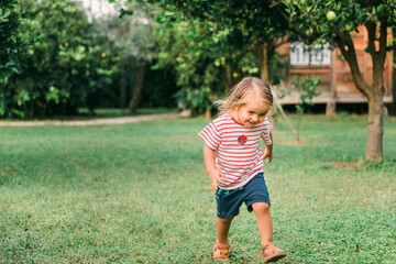 Toddler girl running in garden