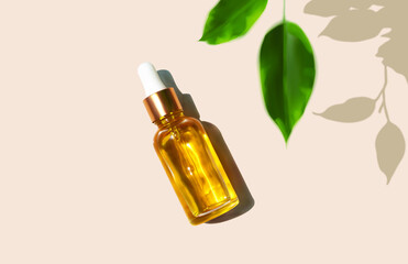 Oil serum glass bottle and defocused leaves with trendy hard shadow on beige background realistic vector illustration, top view. Aromatherapy oil, concept of natural cosmetic